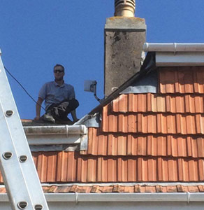 engineer installing 4G broadband aerial in roof